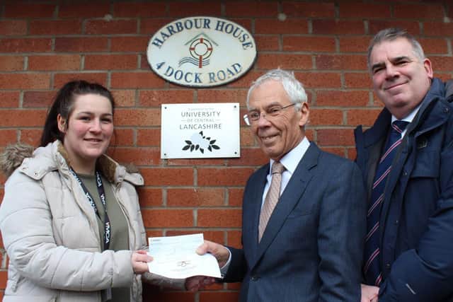 Roger Weston presents £350 Lodge of Triumph cheque to Aimee Townsend of YMCA. Photo: John Topping