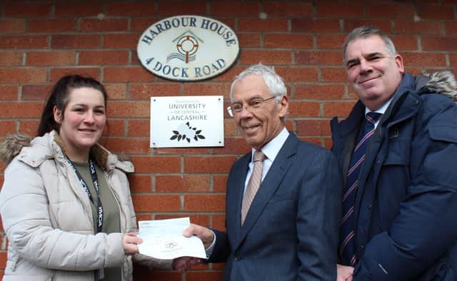 Roger Weston presents £350 Lodge of Triumph cheque to Aimee Townsend of YMCA. Photo: John Topping