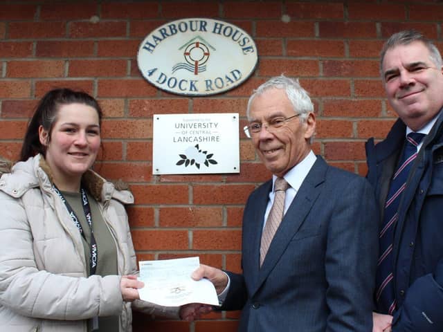 Roger Weston presents £350 Lodge of Triumph cheque to Aimee Townsend of YMCA. Photo: John Topping