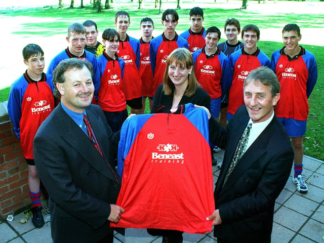 Mike Ruman, general manager of Beneast Training, handing over a new football team kit, to Geoff Jenkins who was St Mary's RC High School year eleven soccer team coach, watched by the team. Also pictured is Beneast Marketing Manager - Vicky Wright 1997