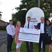 St George’s Golf Day organisers Mick Threlfall and Mark Leech present a cheque for £20,511 to Trinity Hospice, to be split between Trinity, ABF The Soldiers’ Charity
and Pear Tree Holiday Club. It takes the event’s fundraising to over £100,000 for local charities