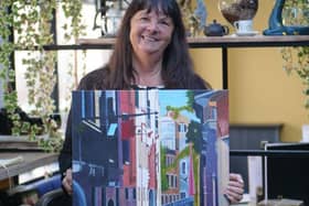 Lesley Keeler holding her painting.