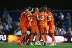 Josh Bowler is mobbed after scoring Blackpool's match winner in first-half stoppage time