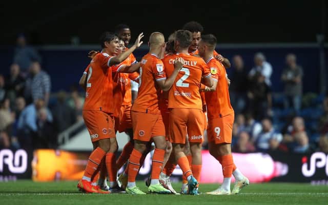 Josh Bowler is mobbed after scoring Blackpool's match winner in first-half stoppage time