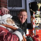 Michael Smith with his Santa and soldier figures outside his home on Warbreck Drive