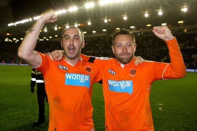 Dobbie celebrates with Gary Taylor-Fletcher after helping Blackpool qualify for the Championship play-off final in 2012