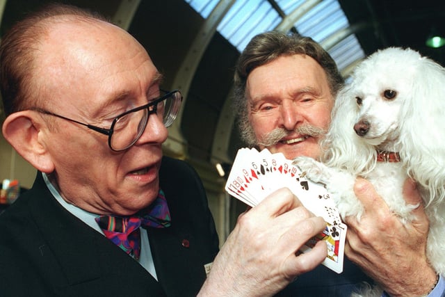 Mark Raffles and his dog Twinkle pick a card from Ali Bongo (left) during the international magic convention at the Winter Gardens