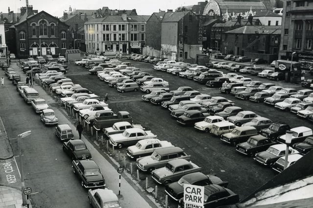 Winifred Street Car Park, seen from Albert Road in 1964. Trinity Methodist Church on Adelaide Street can be seen on the left beyond the car park and the rear of the Co-op Emporium  on Sheppard Street, n the far right. Albert Road car park was built on this site, and Houndshill, its car park and the former Debenhams eventually took its place