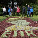 Members of the Friends of Stanley Park celebrating the Queen's Award at the floral clock
