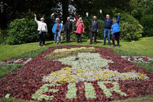 Members of the Friends of Stanley Park celebrating the Queen's Award at the floral clock