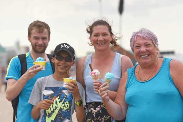 Holidaymakers and locals enjoy one of the hottest days of the year in Blackpool on July 27 2019. Adam Savage, Aaron Savage, Angela Clarke and Sylvia Savage enjoy an ice cream on Blackpool Prom.