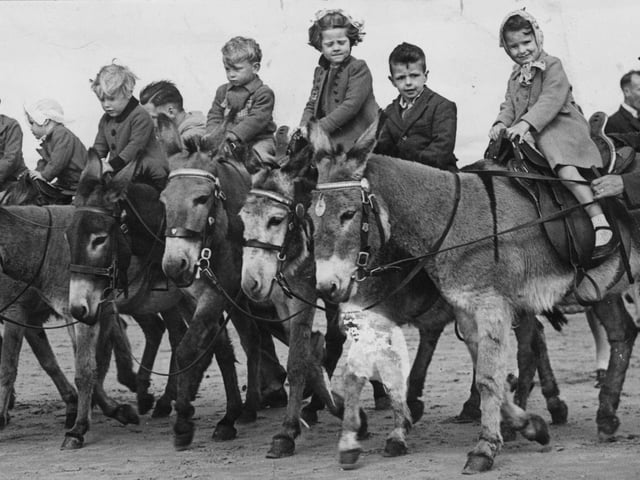 Children in Blackpool enjoying a donkey ride despite war time restrictions on coastal holidays, 1943