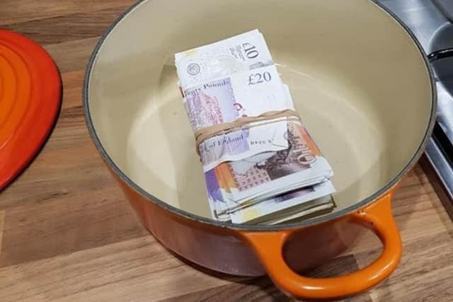 Cash found in a cooking pot at Michael Welsh's address (Credit: Lancashire Police)