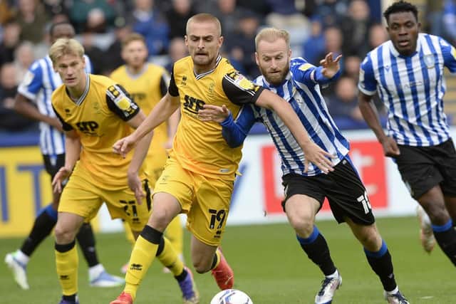 Fiorini battles for the ball for the Imps against Sheffield Wednesday's Barry Bannan last season