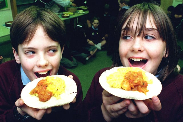 Eleven year old Samantha Parkinson and ten year old Thomas Wilkin get to grips with Pappadums, rice and curry, as part of their project on India at Marton County Primary School.