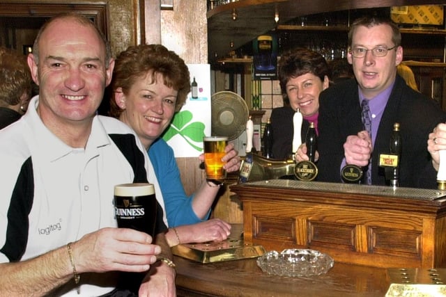 Scruffy Murphy's managers Jim Molyneux and Julie Green enjoy their drinks, served by Punch Independent Pubs executives Lorraine Fanning and Bruce Wakeling, 2000