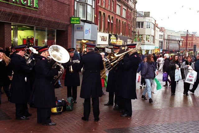 The Salvation Army brass band blast out a few tunes to get Christmas shoppers in the festive spirit, 1997
