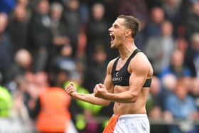 Jerry Yates celebrates with the Blackpool fans after netting a THIRD brace in just four games