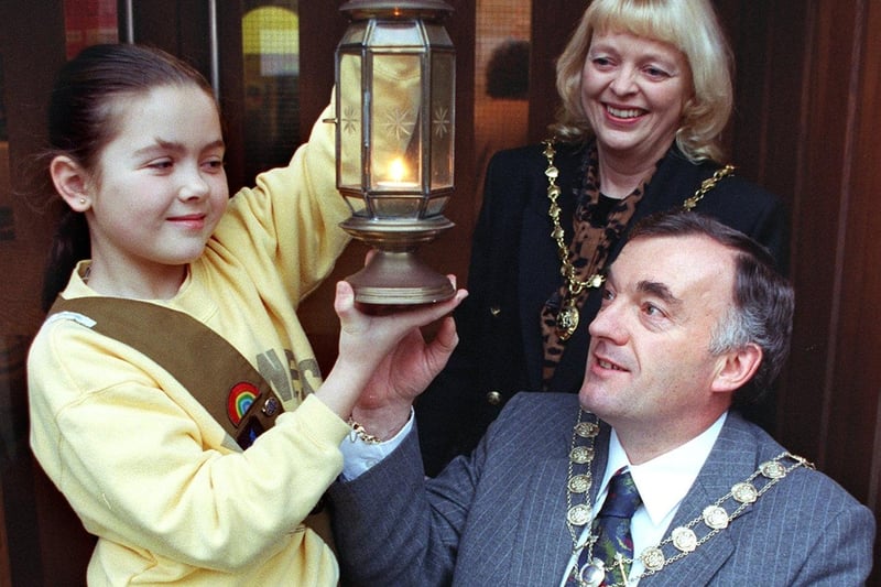 Blackpool North Division Guide Association Carol Service at St John's Church. Nine year old Joanne Ford of the 2nd Bispham Brownies, shows the Light of Peace to the Deputy Mayor of Blackpool - Councillor Don Clapham and the Deputy Mayoress - Mrs Jill Clapham, 1998