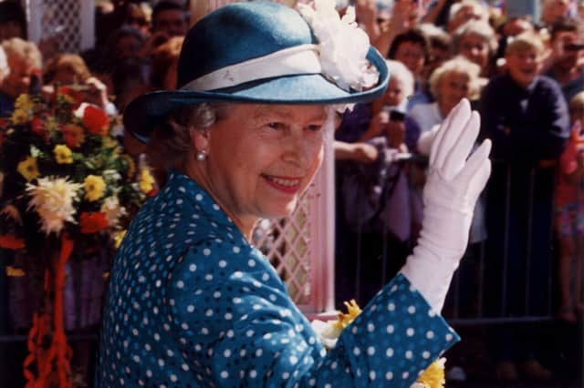 A distinguished royal wave from Queen Elizabeth to well-wishers in Blackpool, 1994