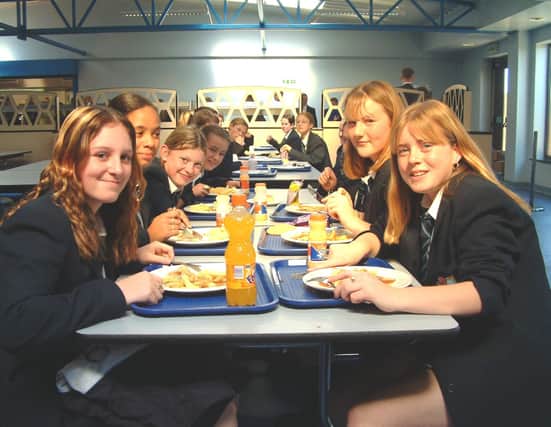 Time for lunch - girls tuck in to their meals inside the school's canteen
