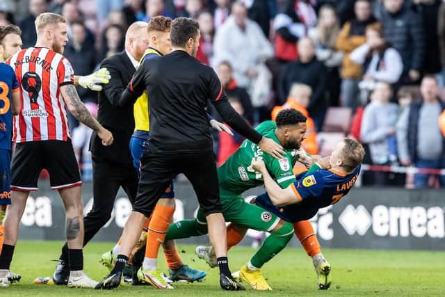 The game ended in farcical scenes when Wes Foderingham barged Shayne Lavery to the ground