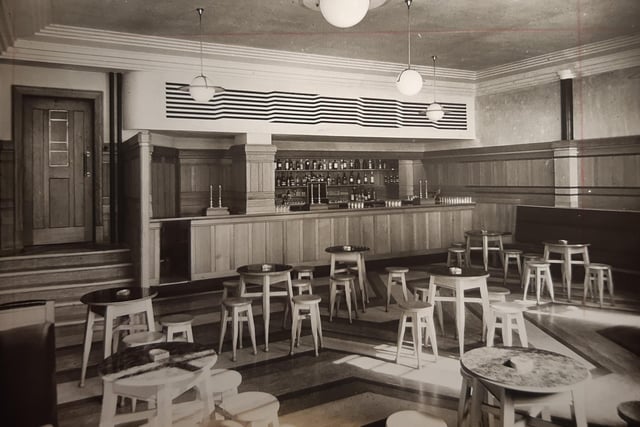 This is a 1936 photo too and the caption reads: 'The new saloon bar at the Palatine Hotel has oak-panelled walls and a patterned rubber floor. The bar service can be flood-lit