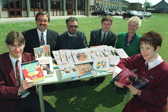 Rev Simon Cox, Rector of Bispham Parish Church,  handing over some of the books, videos and CD Roms to representatives of Montgomery High School in 1997. Pictured are head boy Peter Graham, Headteacher Paul Moss,  Rev Cox,  David Cairns (R.E. Dept), Senior Teacher, Viv Firth and head girl Claire Graham
