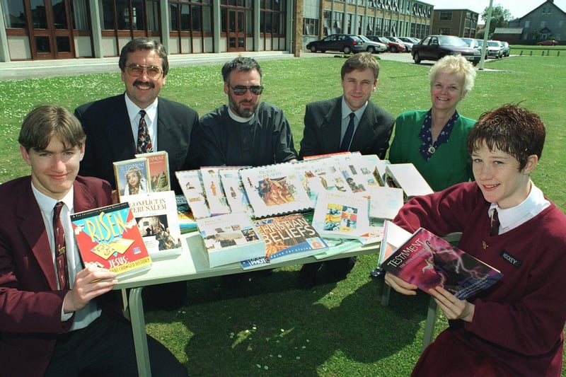 The Rev Simon Cox (Rector of  Bispham Parish Church),  hands over books, videos and CD Roms to representatives of Montgomery High School. From left, head boy Peter Graham, Headteacher Paul Moss,  Rev. Cox,  Mr David Cairns (R.E. Dept), Senior Teacher Miss Viv. Firth and head girl Claire Graham