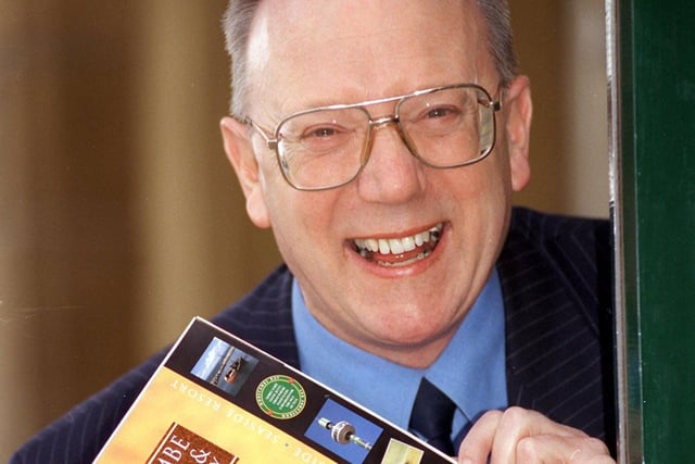 Ron Sands holds a copy of the 1999 Lancaster Morecambe and Lune Valley holiday brochure