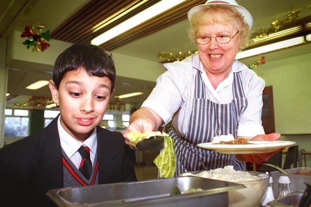 Pupils at Warbreck High School had a taste of the 50s when dinner ladies cooked up a typical school dinner from that era in 1999. Pic shows Joshua Lalgee (13) grimacing at the prospect of cabbage, served by Unit Manager Ann Fiddies