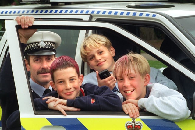 PC Eric Taylor with youngsters Mark Stirzaker, 12, Andrew Murchie, 12, and Lawrence Jennings, 11, check out one of the police force's new motorway patrol vehicles, on display at Garstang High School gala