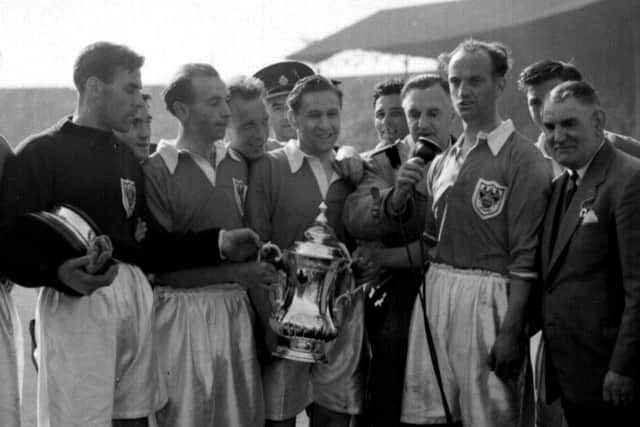 Stanley Matthews and his Blackpool teammates celebrate with the cup