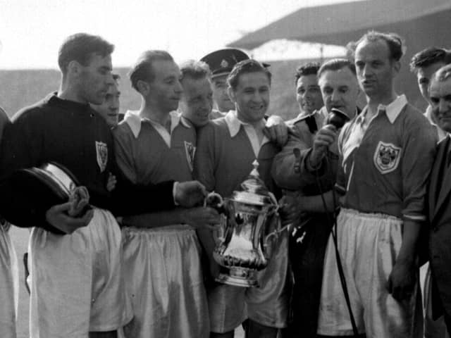 Stanley Matthews and his Blackpool teammates celebrate with the cup