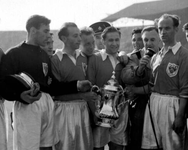 Stanley Matthews and his Blackpool teammates celebrate with the cup