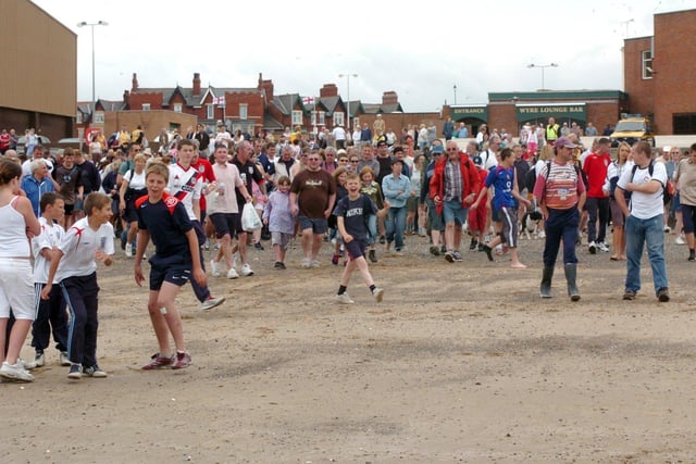 The crowds gathered on the beach behind the Marine Hall ready for the walk out to Wyre Light. This was in 2006.