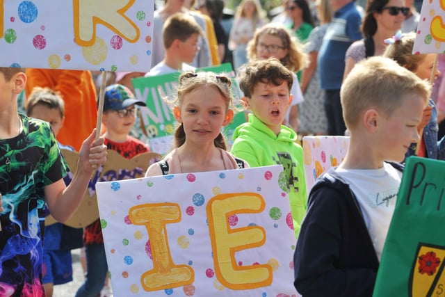 Members of the community take part in the Freckleton Club Day procession through the village.