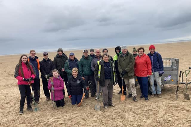 BBC Countryfile presenter Tom Heap with Lancashire Wildlife Trust officers and volunteers on the beach at St Annes