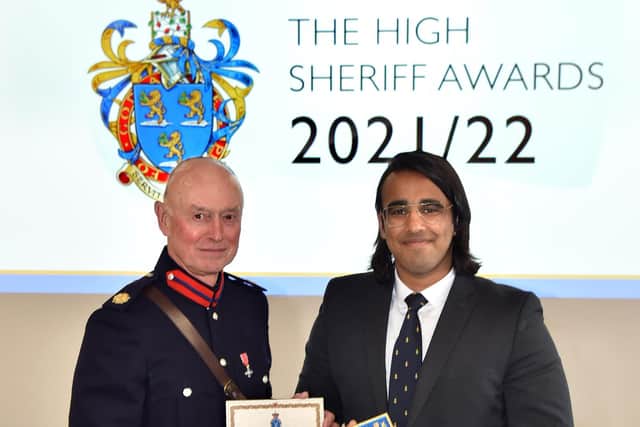 Outstanding community work - Dilip Gosal receives his award from the High Sheriff of Lancashire
