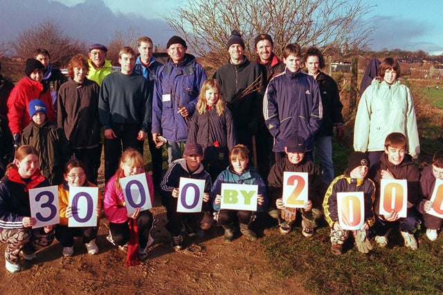 Pupils at Handsworth Grange school in 1999 where students, parents, teachers and local residents were out to plant the  Millennium hedge containing 1000 trees.  The sign shows that the group has planted 3000 trees  by the year 2000.