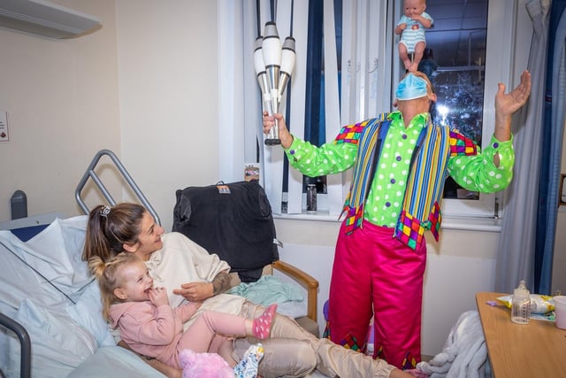 Steve Royle as Silly Billy delighted with his juggling skills during the Sleeping Beauty cast's visit to the children's ward at Blackpool Victoria Hospital.