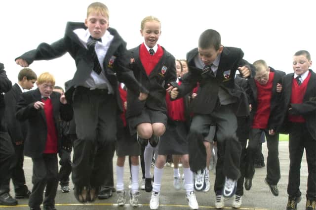 Pupils are pictured taking part in the world record jump bid, 2001
