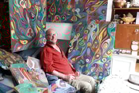 Phil Walters with some of the paintings at his Fleetwood home
