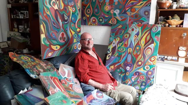 Phil Walters with some of the paintings at his Fleetwood home