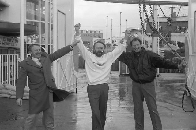 Escapologist John Roberto braved his winds at Blackpool to herald a top magic convention - hanging in a straitjacket 75ft above the ground on a burning rope. John - who escaped in the nick of time - was one of several artists who gave an impromptu free show on Blackpol Promenade. John is pictured above with Derek Lever, president of Blackpool Magicians Club, and convention organiser Tom Owen