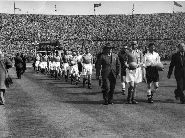 Manager Joe Smith and captain Harry Johnston lead out the Seasiders