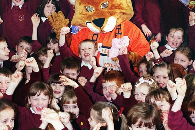 Blackpool Football Club mascot Cable Cat dropped in on children from Ansdell County Primary School to invite them to Bloomfield Rd on Saturday for "Quid a Kid" in 1999