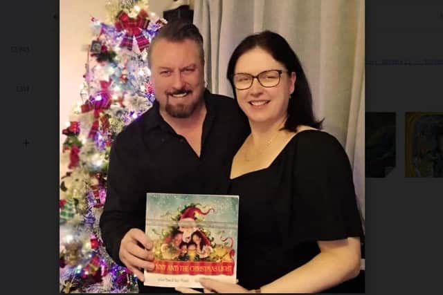 Tony and Dawn Mitchell with a copy of their children's book,  Danny and the Christmas Light