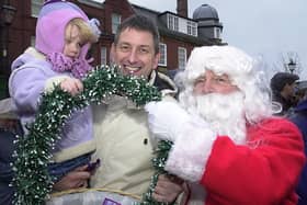 Santa is on hand to give out sweets to Carl York and Alice, two at the Lytham Christmas lights switch-on in 2002
