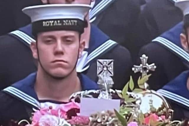 Alex Stuart, 19, beside the Queen's coffin during Her Majesty's funeral procession on Monday, September 19